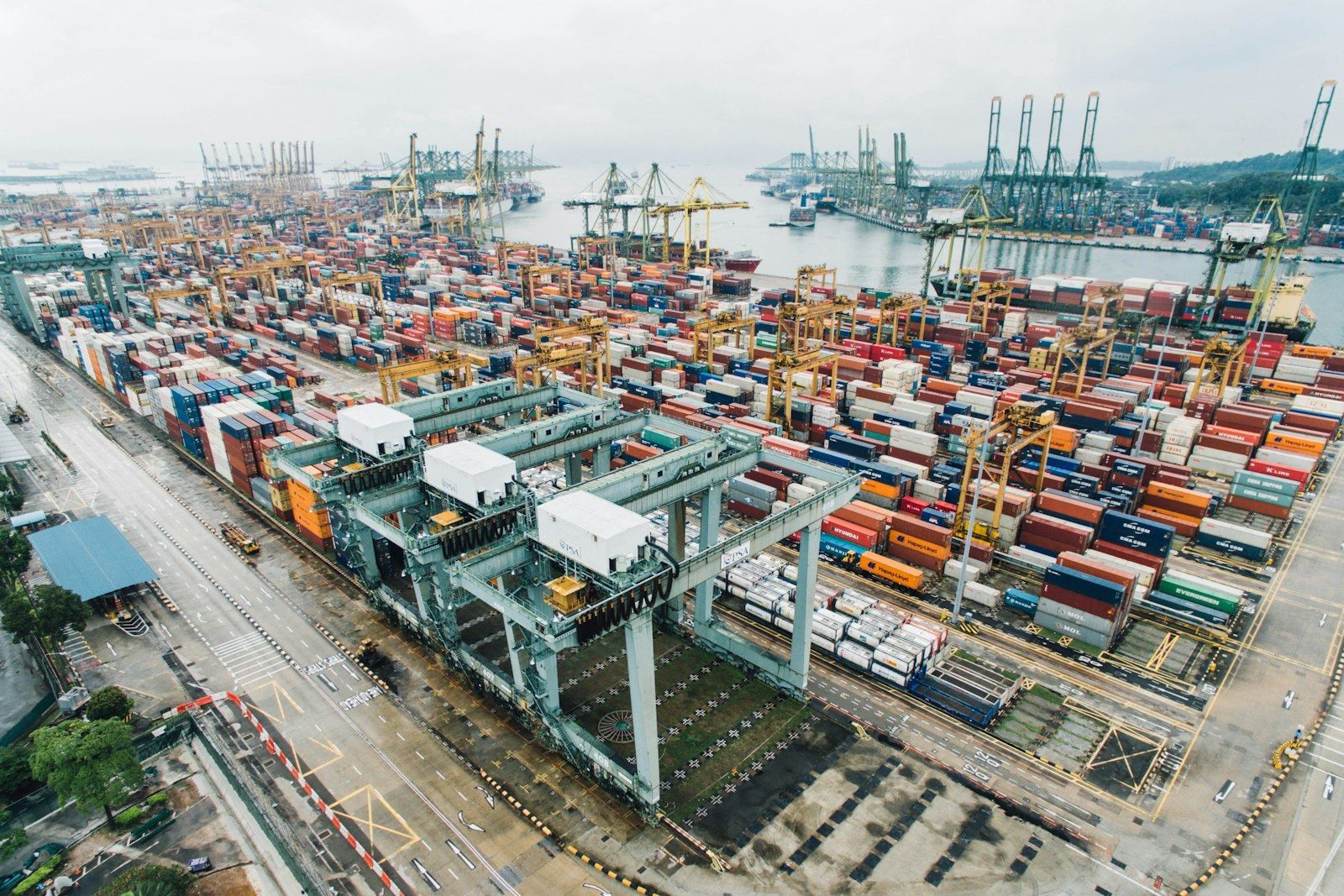 Container port with cranes and stacked containers