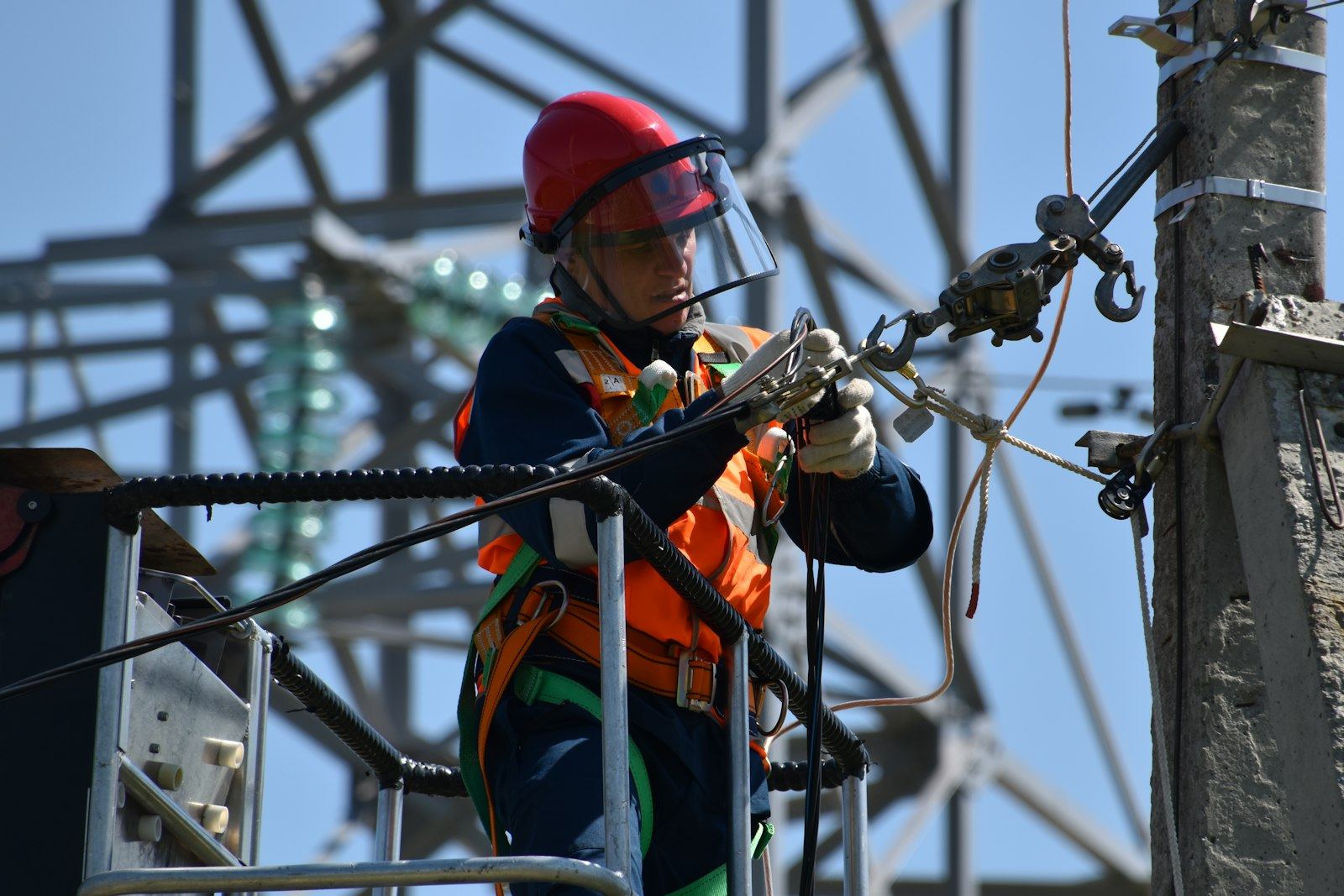 Technician on a power transmission tower